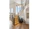 Elegant curved staircase with wooden steps, metal railings, and a modern chandelier at 11453 Glowing Sunset Ln, Las Vegas, NV 89135