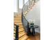 Beautiful staircase with illuminated wooden steps, a curved metal railing, and modern decor at 11453 Glowing Sunset Ln, Las Vegas, NV 89135