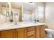 Bright bathroom with a double vanity, mirror, and modern fixtures at 11894 Snow Bank St, Las Vegas, NV 89183