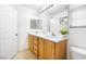 Bright bathroom featuring a double sink vanity, large mirror, and contemporary finishes at 11894 Snow Bank St, Las Vegas, NV 89183