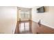Bedroom with wood floors and large window with blinds at 11894 Snow Bank St, Las Vegas, NV 89183