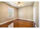 Bedroom features hardwood floors, a ceiling fan, and a large window at 11894 Snow Bank St, Las Vegas, NV 89183
