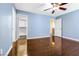Bedroom with wood floors, blue walls and ceiling fan at 11894 Snow Bank St, Las Vegas, NV 89183