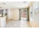 Dining area featuring tile floors, large windows, and sliding glass doors leading to the backyard at 11894 Snow Bank St, Las Vegas, NV 89183