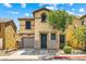Two-story home featuring tan stucco, a tile roof, a well-manicured lawn, and an attached garage at 11894 Snow Bank St, Las Vegas, NV 89183