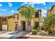 Two-story home featuring tan stucco, a tile roof, a well-manicured lawn, and an attached garage at 11894 Snow Bank St, Las Vegas, NV 89183