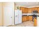Well-lit kitchen features wooden cabinetry, black countertops and stainless steel appliances at 11894 Snow Bank St, Las Vegas, NV 89183
