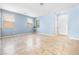 Bright, open living room featuring neutral walls, large windows, and stylish tile flooring at 11894 Snow Bank St, Las Vegas, NV 89183