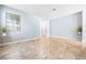 Bright, open living room featuring neutral walls, a large window, and stylish tile flooring at 11894 Snow Bank St, Las Vegas, NV 89183