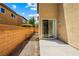 View of the home's outdoor concrete patio, adjacent walk area, and sliding glass doors at 11894 Snow Bank St, Las Vegas, NV 89183
