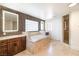 Luxurious bathroom with a soaking tub, a glass-enclosed shower, and custom vanities at 1319 Red Baron Ln, Boulder City, NV 89005