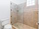 Bright bathroom features a toilet and a walk-in shower with custom tile work at 1319 Red Baron Ln, Boulder City, NV 89005