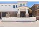 Beautiful two-story home with stone accents, a decorative iron door, and lush landscaping enhances curb appeal at 1319 Red Baron Ln, Boulder City, NV 89005