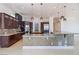 Large open kitchen features dark wood cabinets, granite countertops and an island with a bar sink at 1319 Red Baron Ln, Boulder City, NV 89005