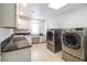 Spacious laundry room with modern washer and dryer and granite countertops at 1319 Red Baron Ln, Boulder City, NV 89005