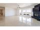 Bright, open living room with large windows, tile floors, and a modern fireplace for relaxation at 1319 Red Baron Ln, Boulder City, NV 89005