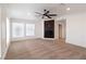 Bright living room with a modern fireplace, large windows, and neutral carpet at 1319 Red Baron Ln, Boulder City, NV 89005