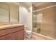 Bathroom featuring a glass-enclosed shower, built-in bench, and a warm-toned tile surround at 15 Via Mantova # 302, Henderson, NV 89011