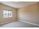 Bright, carpeted bedroom with a view and tan-colored walls at 15 Via Mantova # 302, Henderson, NV 89011