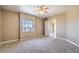 Bright bedroom with scenic views, neutral carpet, a ceiling fan, and an ensuite bathroom at 15 Via Mantova # 302, Henderson, NV 89011