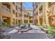 Beautiful courtyard with paver flooring, palm trees, and elegant benches for relaxed outdoor enjoyment at 15 Via Mantova # 302, Henderson, NV 89011