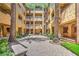 Picturesque courtyard showcasing tall palm trees and brick pavers to add architectural elegance at 15 Via Mantova # 302, Henderson, NV 89011