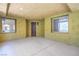 Inviting hallway features textured walls, classic dark wood door and lovely window accents at 15 Via Mantova # 302, Henderson, NV 89011