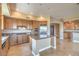 Spacious kitchen featuring stainless steel appliances, granite countertops, a kitchen island, and wood cabinets at 15 Via Mantova # 302, Henderson, NV 89011