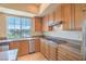 Bright kitchen with stainless steel appliances, granite countertops, and views of the surrounding landscape at 15 Via Mantova # 302, Henderson, NV 89011