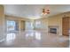 Bright and airy living room boasting tile flooring, a fireplace and private balcony access at 15 Via Mantova # 302, Henderson, NV 89011