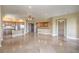 Open-concept living area featuring tile floors, kitchen with stainless steel appliances, and ample entertaining space at 15 Via Mantova # 302, Henderson, NV 89011
