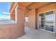 Spacious covered patio with ceiling fan, sliding glass doors, and stunning desert views at 15 Via Mantova # 302, Henderson, NV 89011