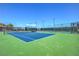 Well-maintained community tennis court with green and blue surface and surrounding fences at 15 Via Mantova # 302, Henderson, NV 89011