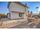 Home's backyard featuring a shaded patio area and gravel landscaping, adjacent to a stucco exterior at 1564 Vegas Valley Dr, Las Vegas, NV 89169