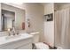 Well-lit bathroom with modern vanity, toilet, and shower with a white curtain at 1564 Vegas Valley Dr, Las Vegas, NV 89169