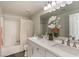 Bright bathroom featuring a double vanity with modern fixtures and a shower-tub combination at 1564 Vegas Valley Dr, Las Vegas, NV 89169