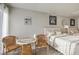 Cozy bedroom featuring two beds, a small table with chairs, and natural light at 1564 Vegas Valley Dr, Las Vegas, NV 89169