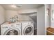 Functional laundry room with modern washer and dryer units and ample space at 1564 Vegas Valley Dr, Las Vegas, NV 89169