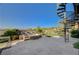 A backyard featuring a spiral staircase, stone water feature, and lush green landscaping at 16 Mallard Creek Trl, Henderson, NV 89052