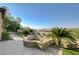 Backyard with a stone water feature, lush landscaping and desert views at 16 Mallard Creek Trl, Henderson, NV 89052