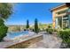 Backyard with a hot tub, outdoor seating, and lush landscaping, perfect for outdoor relaxation at 16 Mallard Creek Trl, Henderson, NV 89052