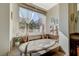 Serene bathroom showcasing a soaking tub with a picturesque window view and vanity at 16 Mallard Creek Trl, Henderson, NV 89052