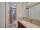 Bathroom features a light-colored vanity, framed mirror, and a tiled shower-tub combination at 16 Mallard Creek Trl, Henderson, NV 89052
