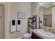 Cozy bathroom features a tile shower, decorative tile accents, and functional storage shelves at 16 Mallard Creek Trl, Henderson, NV 89052
