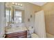 Well-lit bathroom featuring a vanity with a tiled countertop, a toilet, and a shower with patterned tile at 16 Mallard Creek Trl, Henderson, NV 89052