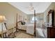 Bedroom featuring a four-poster bed, rocking chair, and dresser at 16 Mallard Creek Trl, Henderson, NV 89052