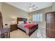 Inviting bedroom featuring a dark wood bed frame, plush bedding, and natural light from shuttered windows at 16 Mallard Creek Trl, Henderson, NV 89052
