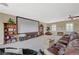 Relaxing bonus room with a screen, comfortable seating, and natural light at 16 Mallard Creek Trl, Henderson, NV 89052