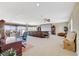 Spacious bonus room with theater screen, comfortable seating, and large windows overlooking the landscape at 16 Mallard Creek Trl, Henderson, NV 89052