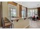 Granite bar and seating in the breakfast nook and dining area with access to patio at 16 Mallard Creek Trl, Henderson, NV 89052